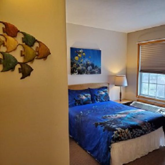 Under‑the‑Sea themed family room decor with fish and ocean artwork at Brook Pointe Resort in Syracuse, Indiana